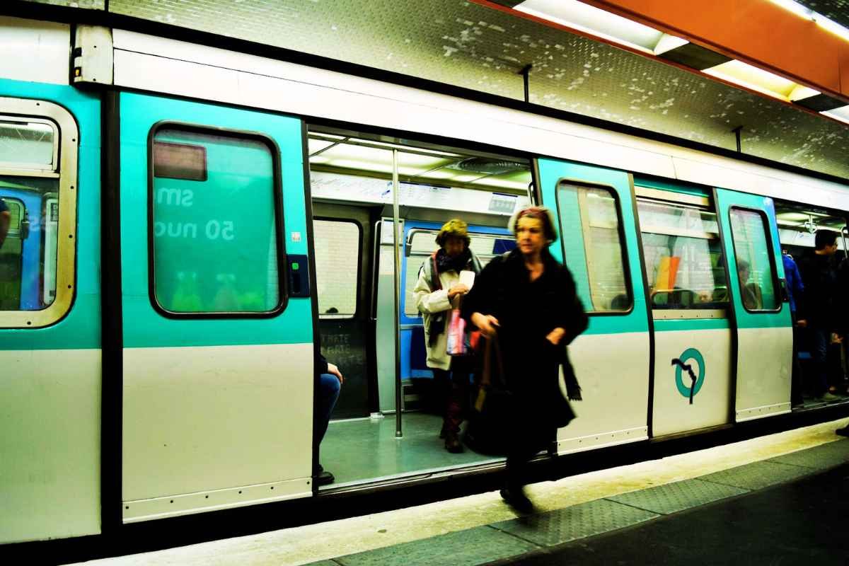 Paris RER train stopping at a station, connecting the city with suburbs, airports, Disneyland and Versailles