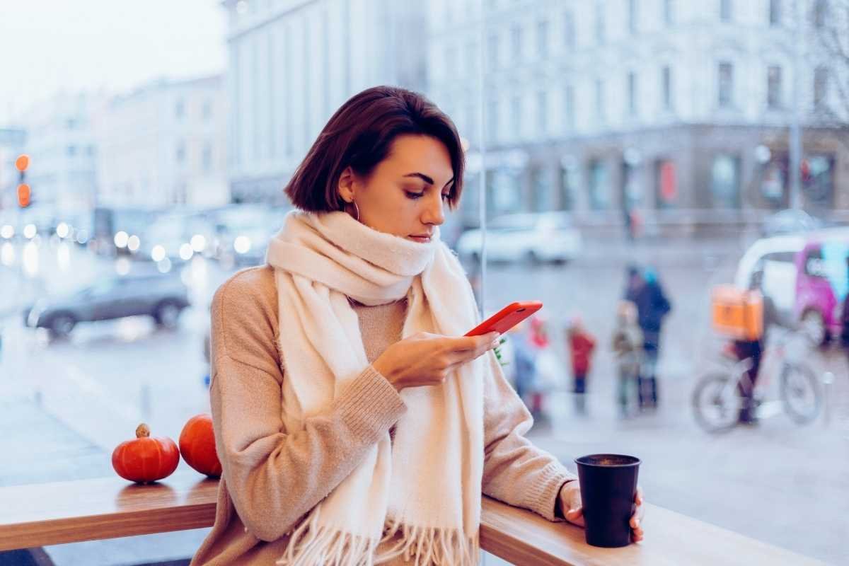 Traveler walking along Paris street on cold winter evening managing daily budget