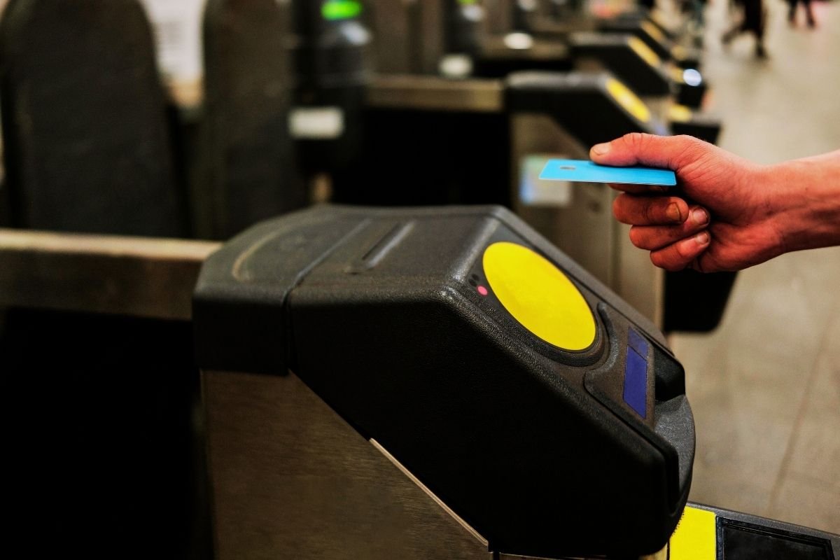 London Budget Guide 2026: contactless tap at a station gate, where a consistent payment identity keeps daily spending controlled