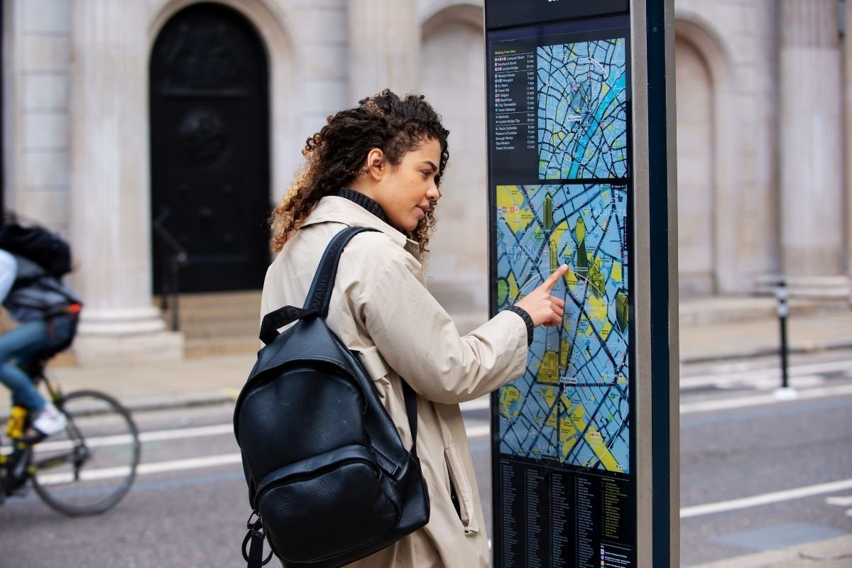 Is Paris good for first-time travelers: a first-time visitor stepping out of a Metro exit and checking directions, showing how the city’s pace and small decisions create stress