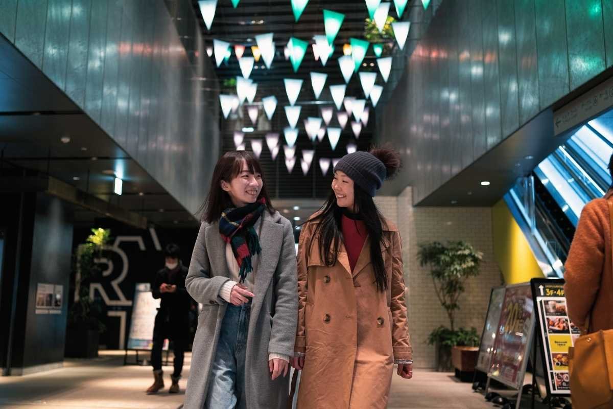 Paris January 2026 indoor event night: people entering a venue with winter coats and short daylight