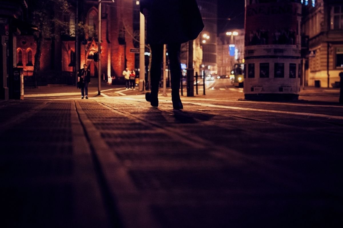 traveler choosing a brighter street corner instead of an empty shortcut, illustrating the calm protocol for reducing risk without panic