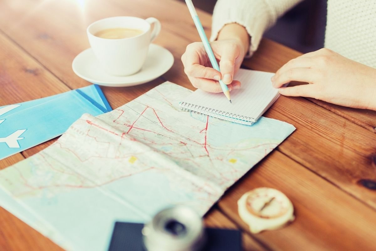 Is Paris good for first-time travelers: traveler planning a simple day with a map and saved notes, showing how structure prevents overwhelm