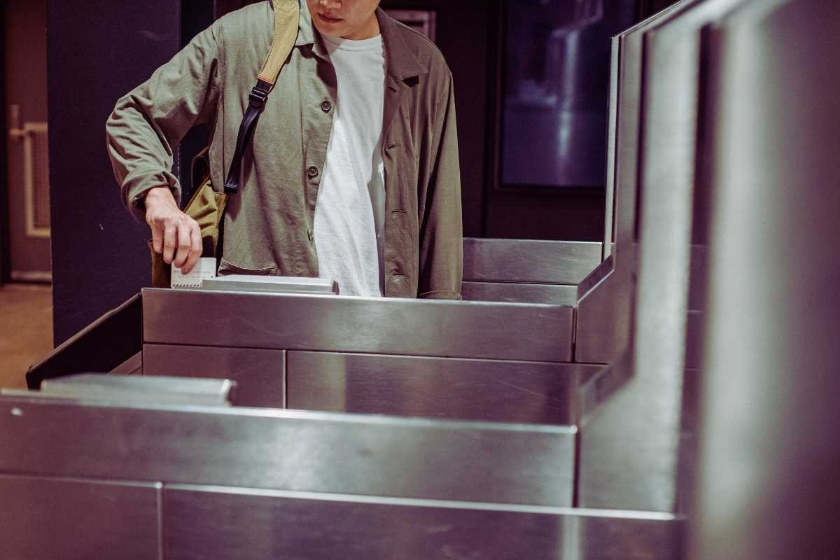 Paris metro entrance in winter traveler using pass to control transport budget