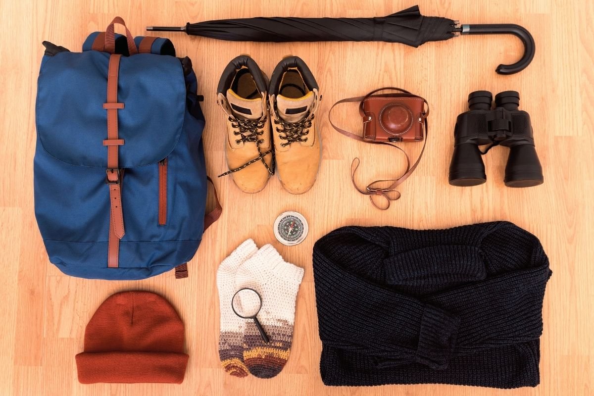 waterproof shoes, compact umbrella, scarf, gloves, mid-layer jacket, and a small day pouch for winter transitions