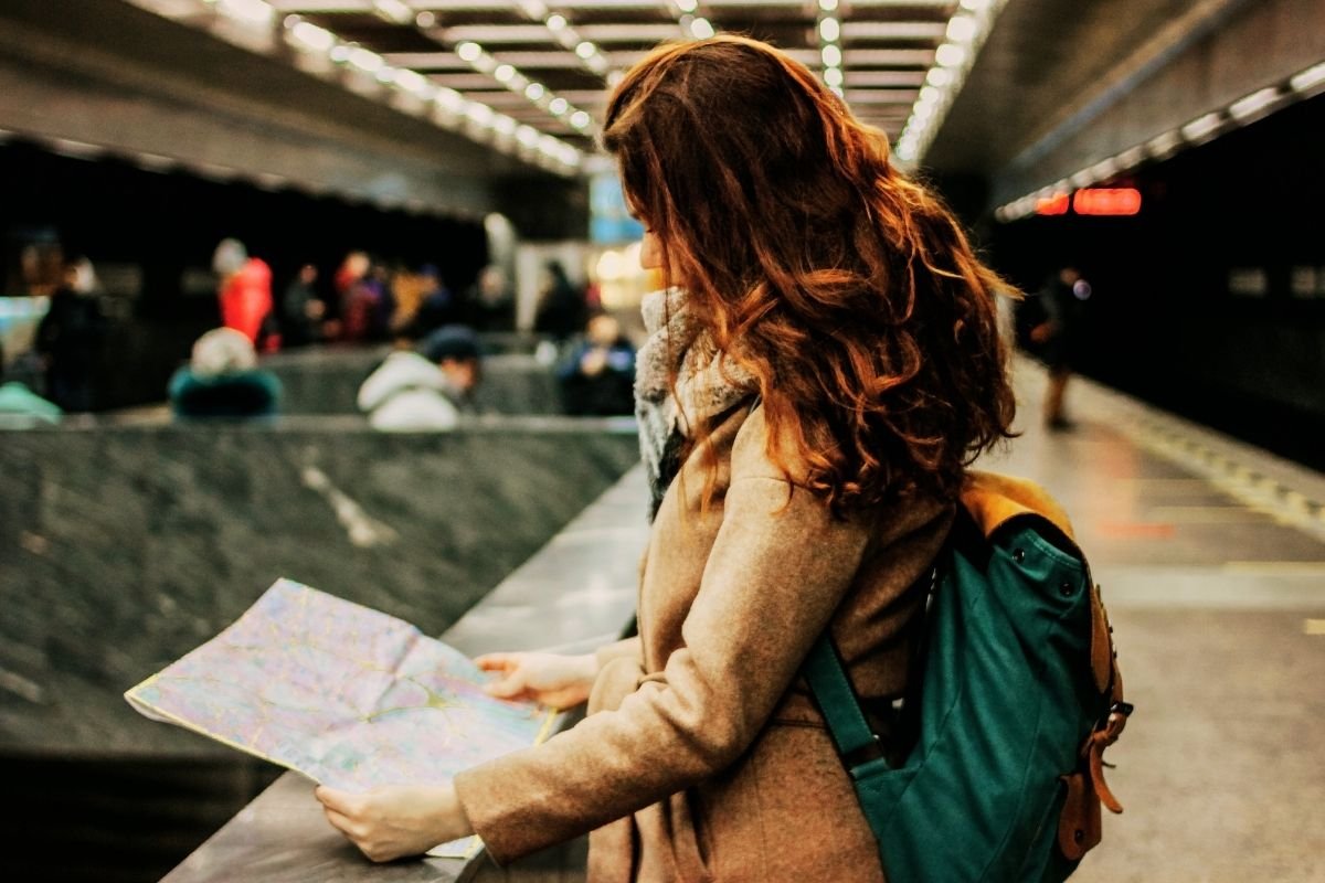 A first-time visitor at Heathrow checking the map, illustrating the stress of choosing the best areas to stay in London for first-time visitors.