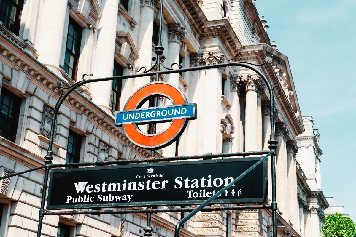 London Underground station sign and map — the station-first logic tourists should use when choosing cheap areas to stay in London