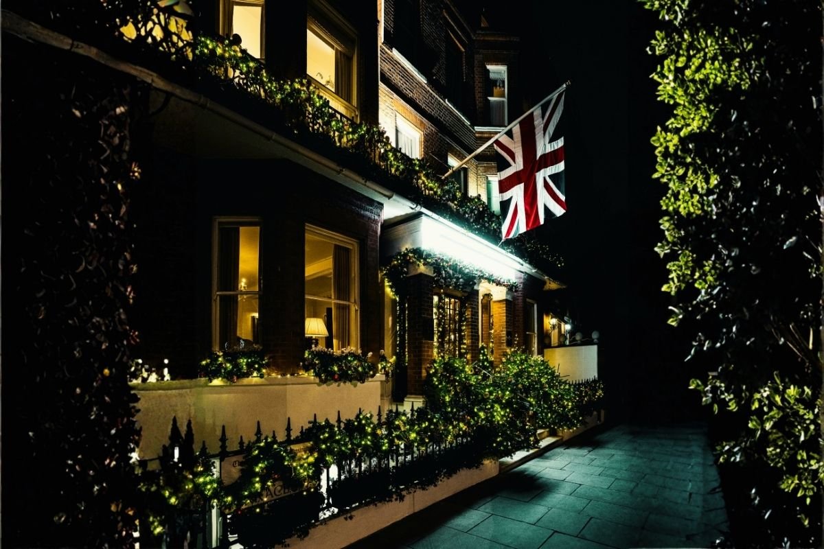 A calm London hotel street at night, highlighting the importance of sleep when choosing where to stay in London for first-time visitors.