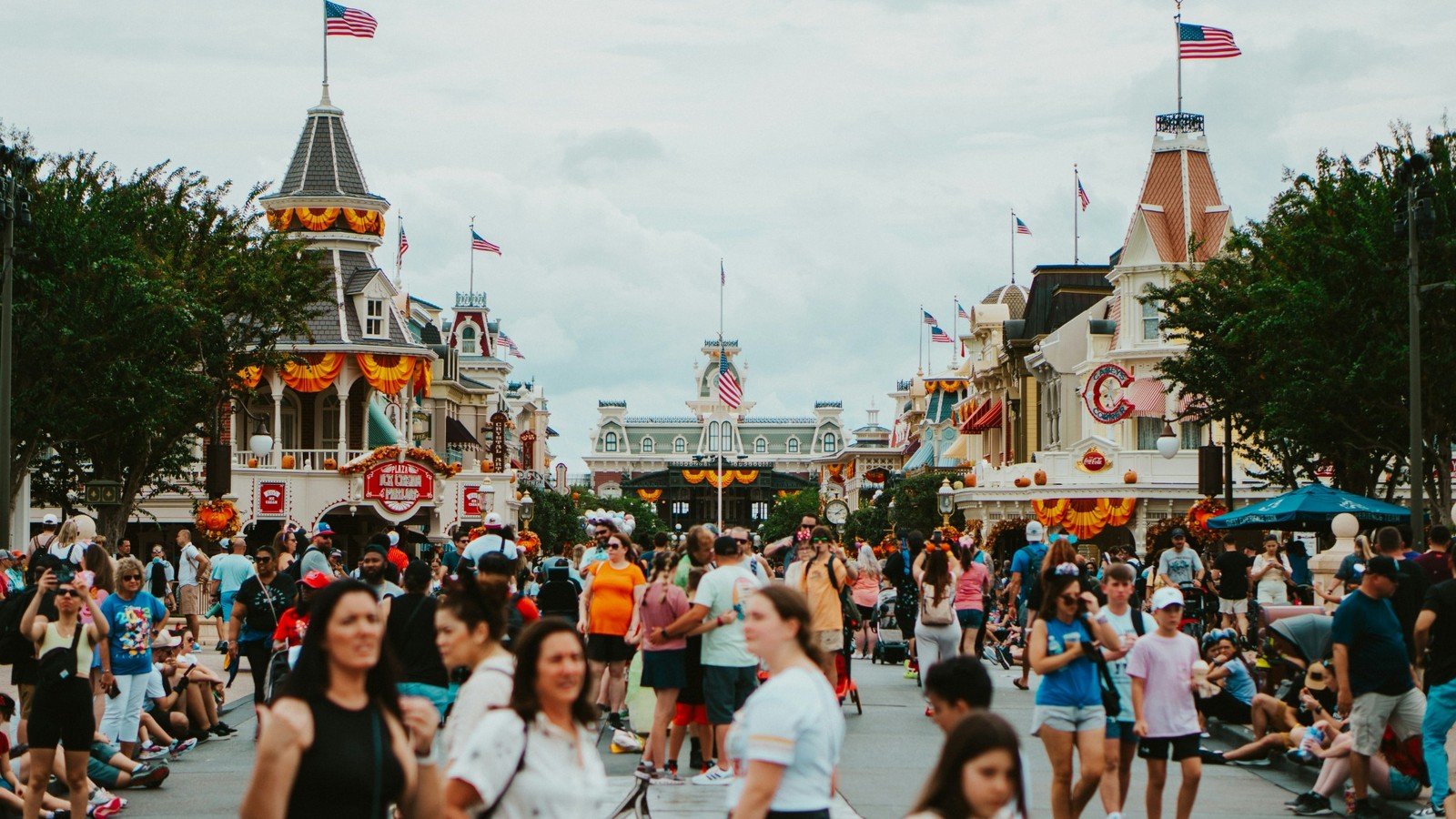 Families walking through a busy Orlando theme park during long park days