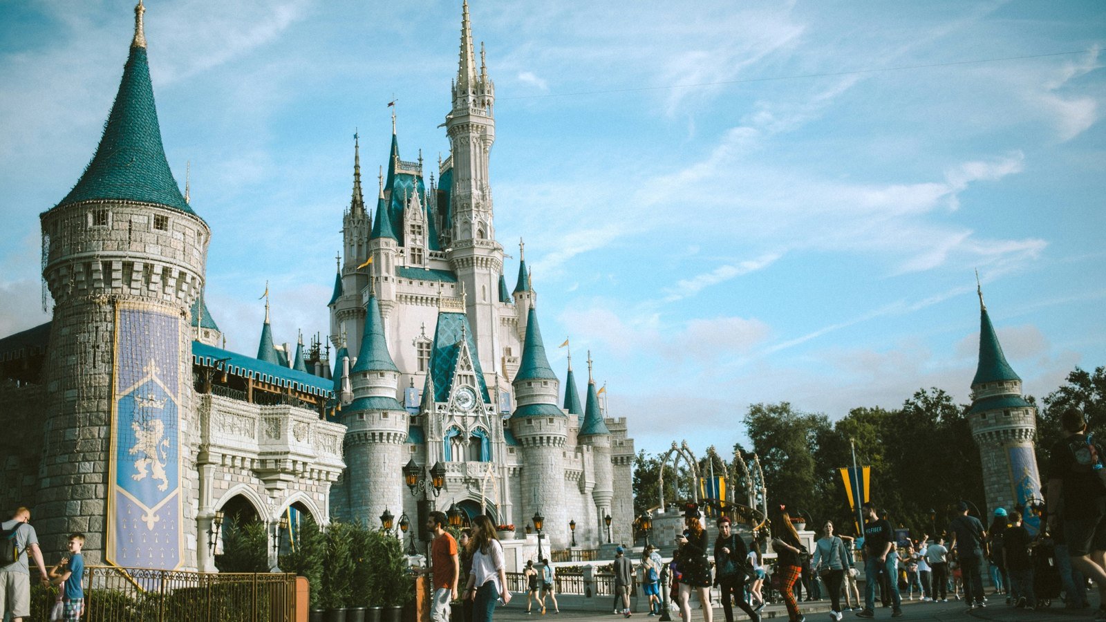 Disney first time Orlando experience First-time visitors walking near a castle inside a large theme park