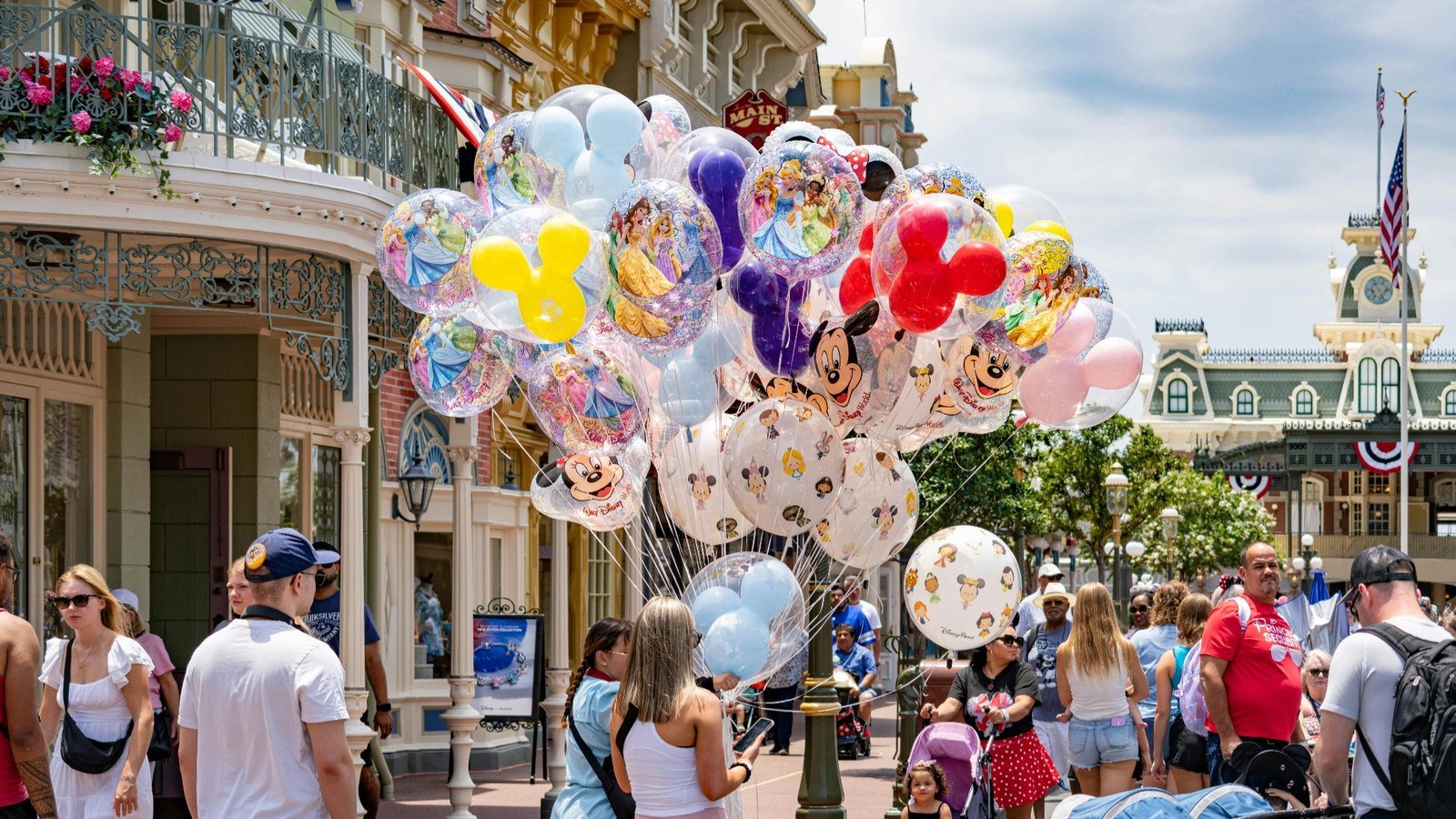 Disney World vacation costs in Orlando Visitors shopping for colorful balloons and souvenirs inside a theme park