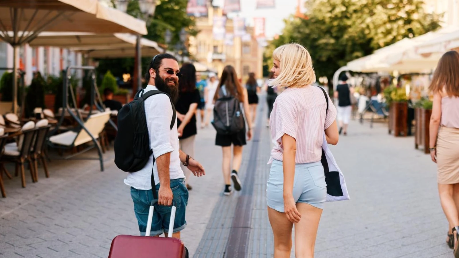Happy travelers exploring a city after arriving for the FIFA World Cup 2026.