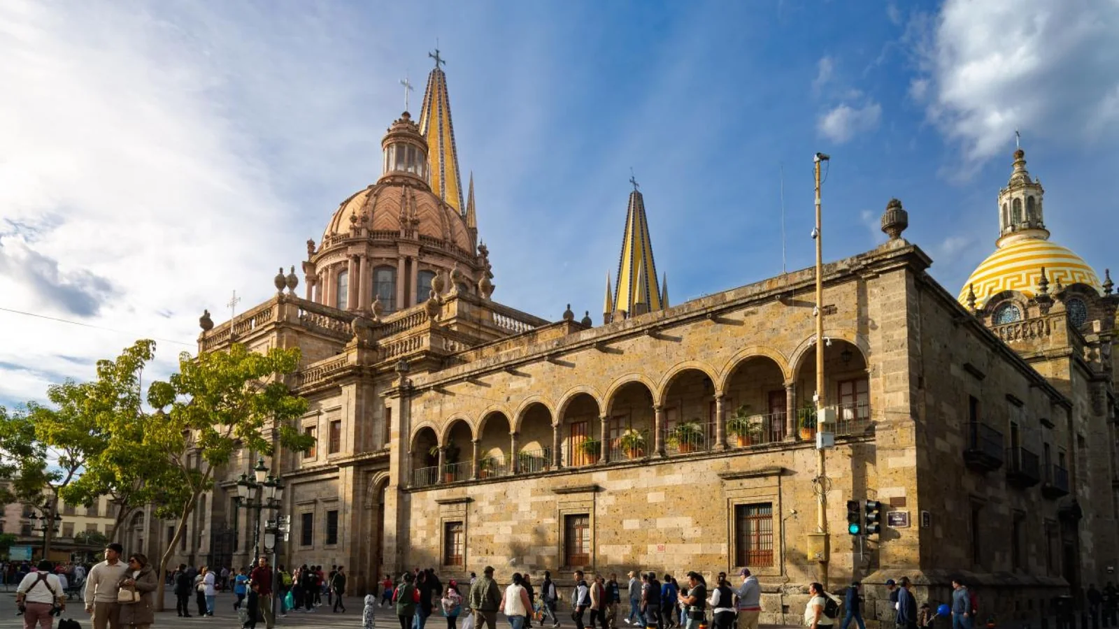 Visitors walking through Guadalajara Plaza beside Guadalajara Cathedral in the historic city center