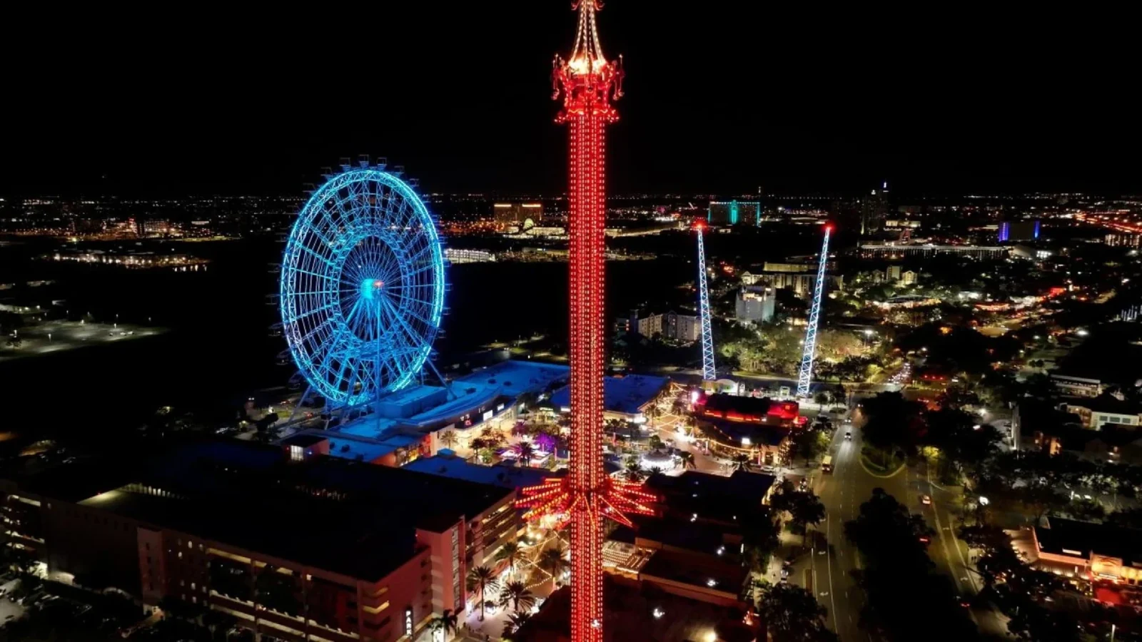 The Orlando Eye and Icon Park illuminated at night along International Drive in Orlando.