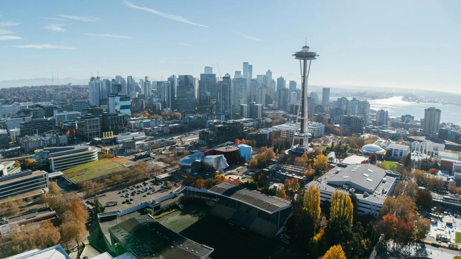Aerial view of Seattle featuring the Space Needle, downtown skyline, and waterfront.