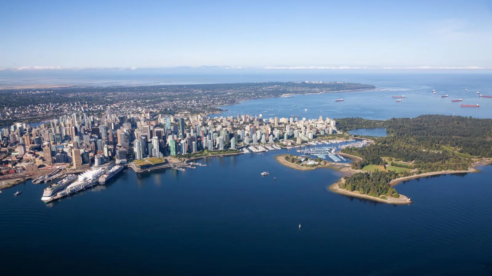 Aerial view of Vancouver skyline with Stanley Park, Canada Place, and the waterfront.