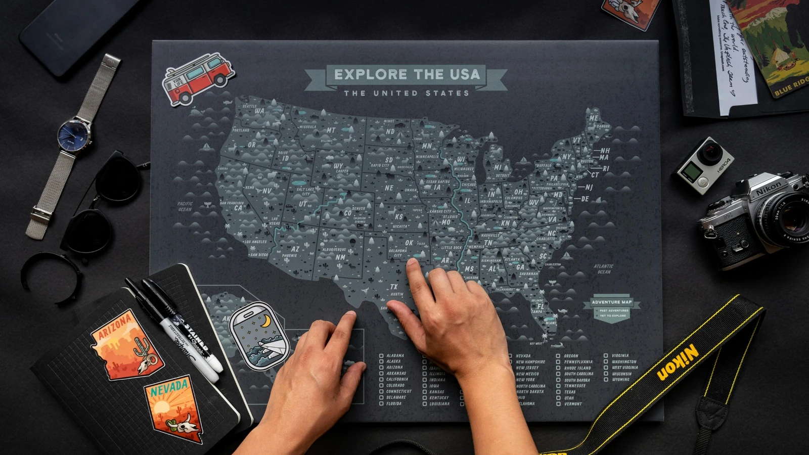 Traveler planning a route across the United States with a travel map.