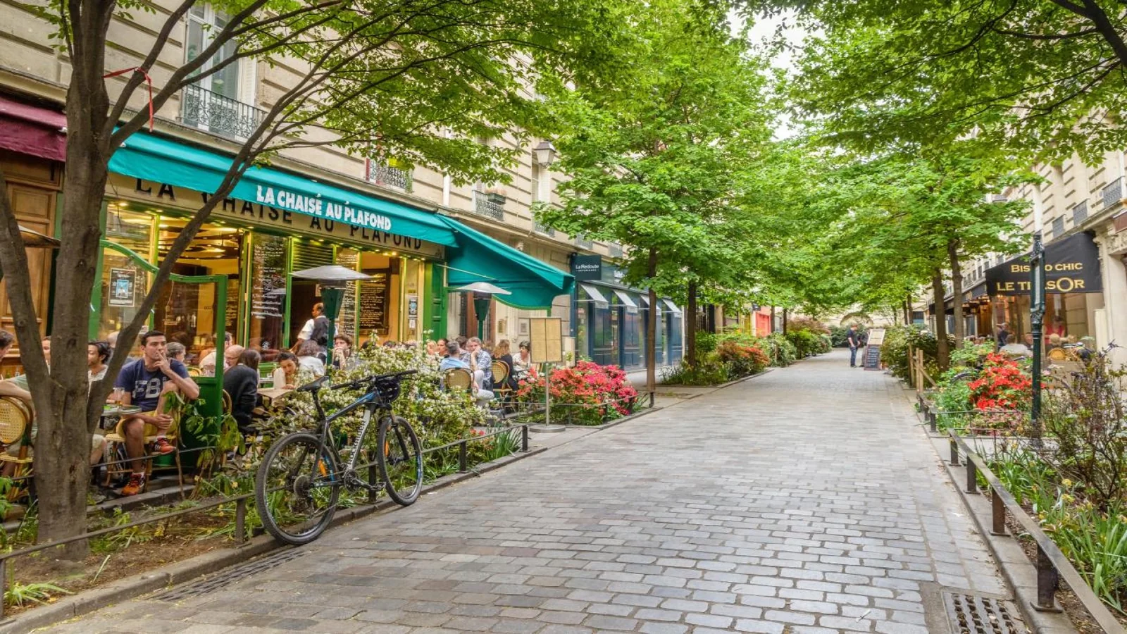 Street lined with cafés and restaurants in Le Marais, one of the best areas to eat in Paris