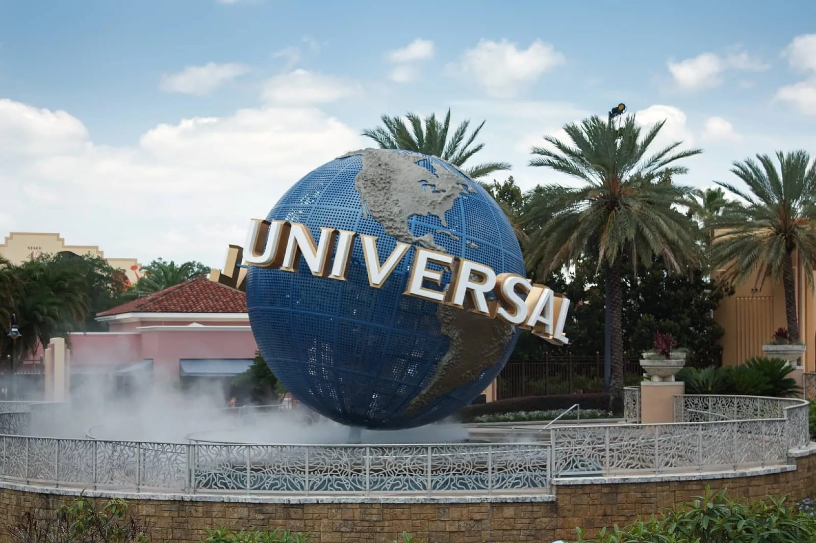 Universal Orlando globe surrounded by palm trees at Universal Orlando Resort.