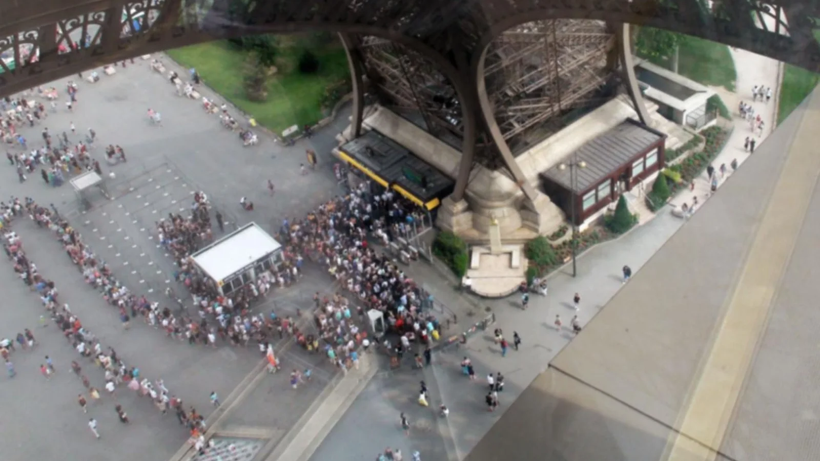 Long visitor lines at the Eiffel Tower entrance in Paris
