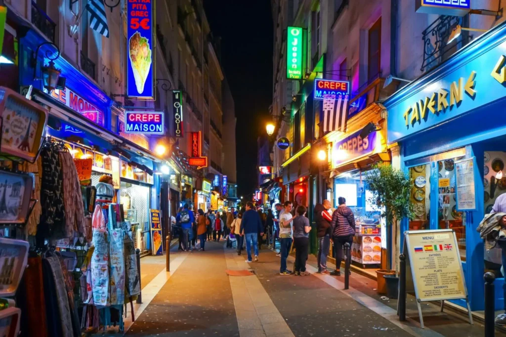 Restaurants and pedestrians on Rue de la Huchette at night