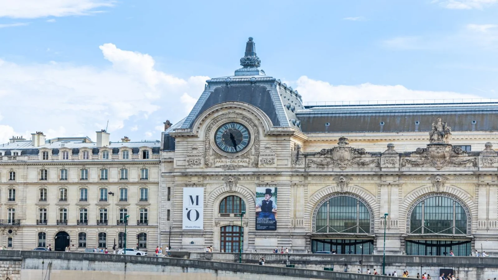 Visitors walking through the Louvre courtyard