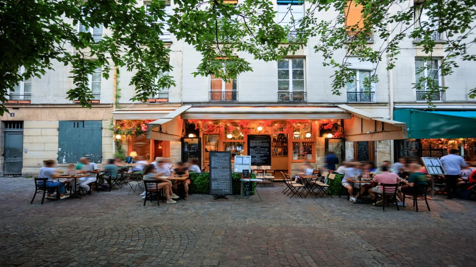 Traditional French bistro with outdoor seating and menu boards