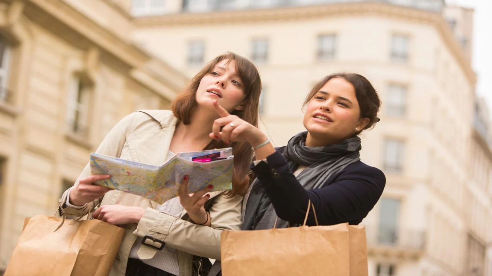 Travelers planning their museum itinerary with a map in Paris