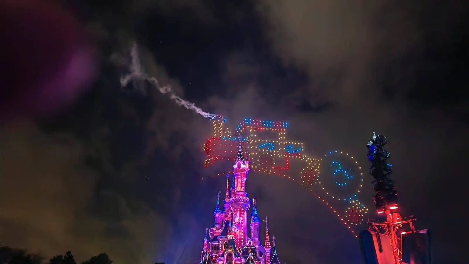 Nighttime drone show above Sleeping Beauty Castle at Disneyland Paris