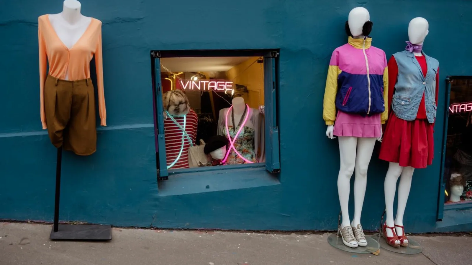 Colorful vintage clothing display outside a Montmartre shop