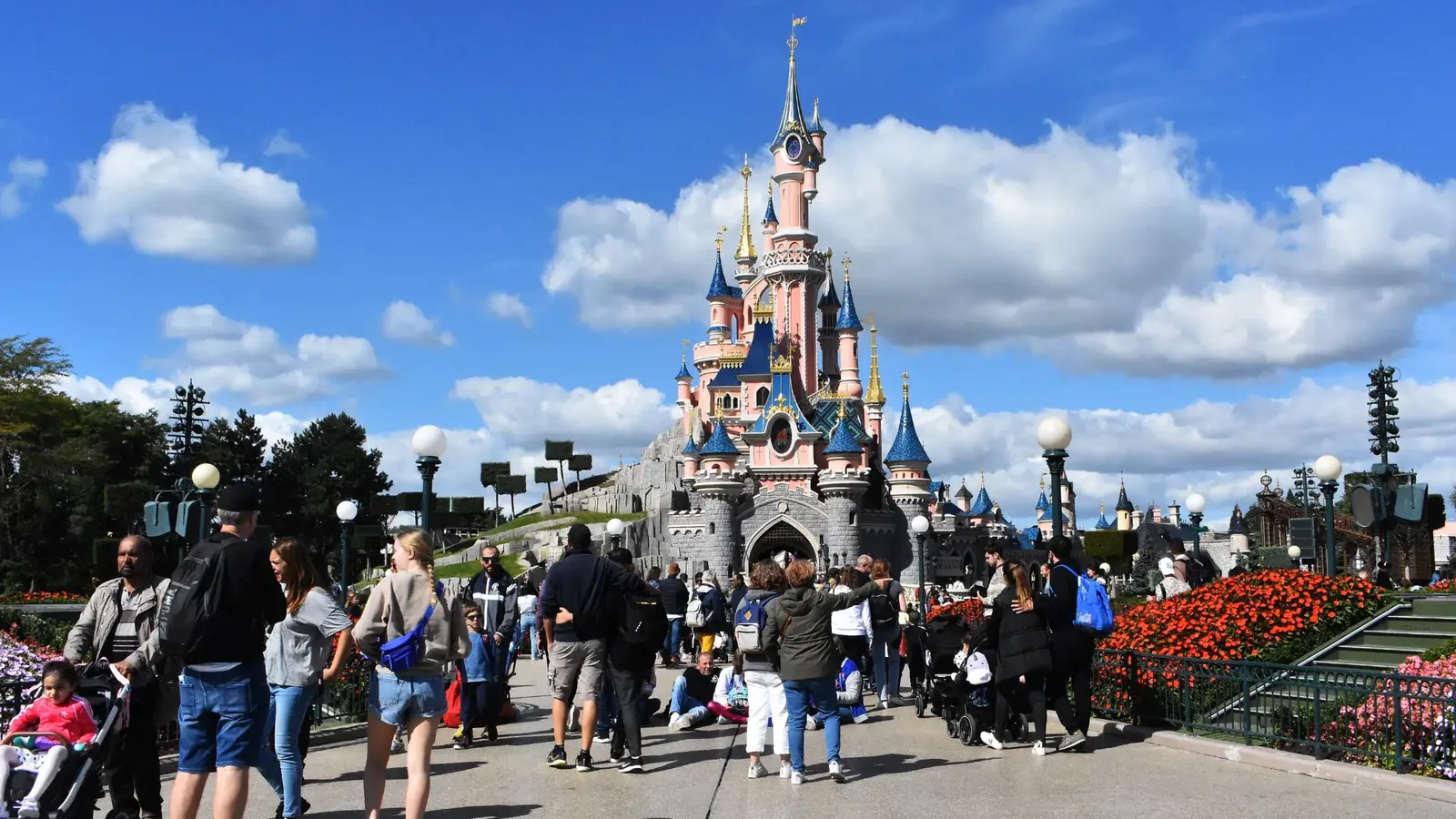 Visitors walking toward Sleeping Beauty Castle