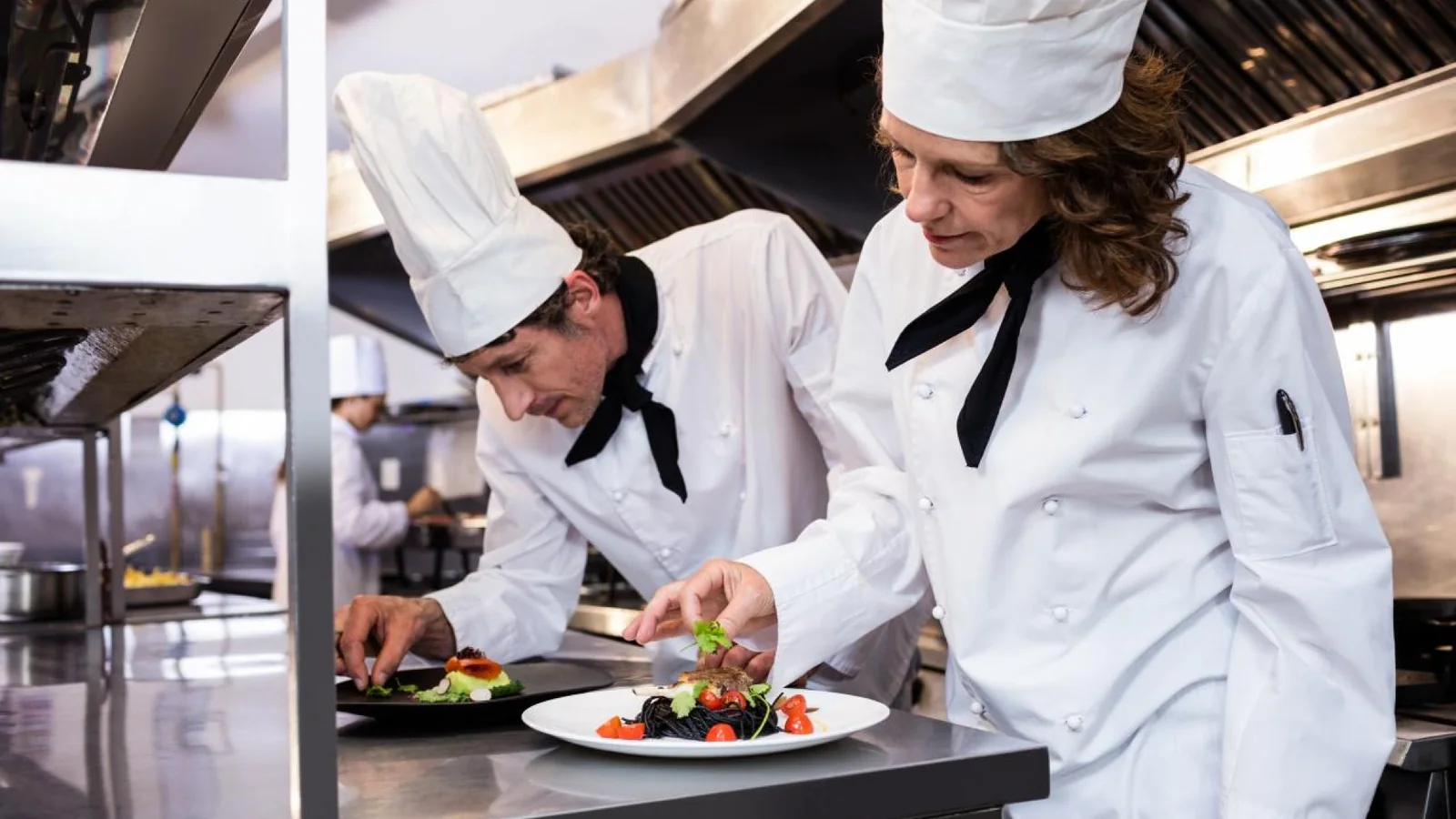 Chefs preparing fine dining dishes for a Michelin restaurant experience