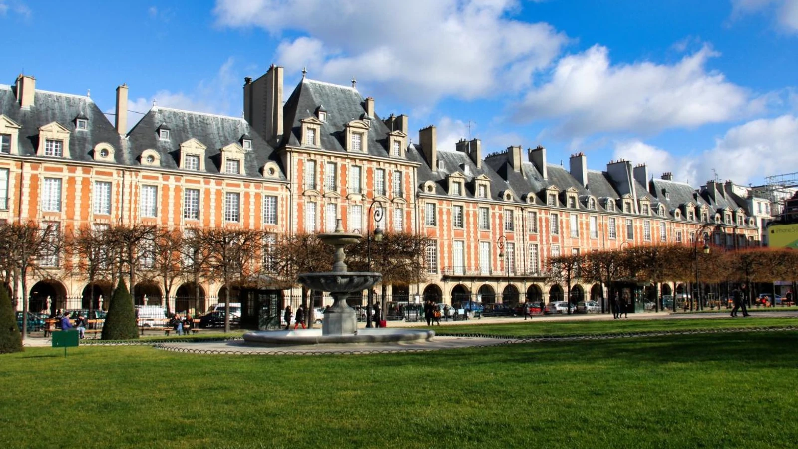 Historic buildings, fountain and gardens at Place des Vosges in Le Marais