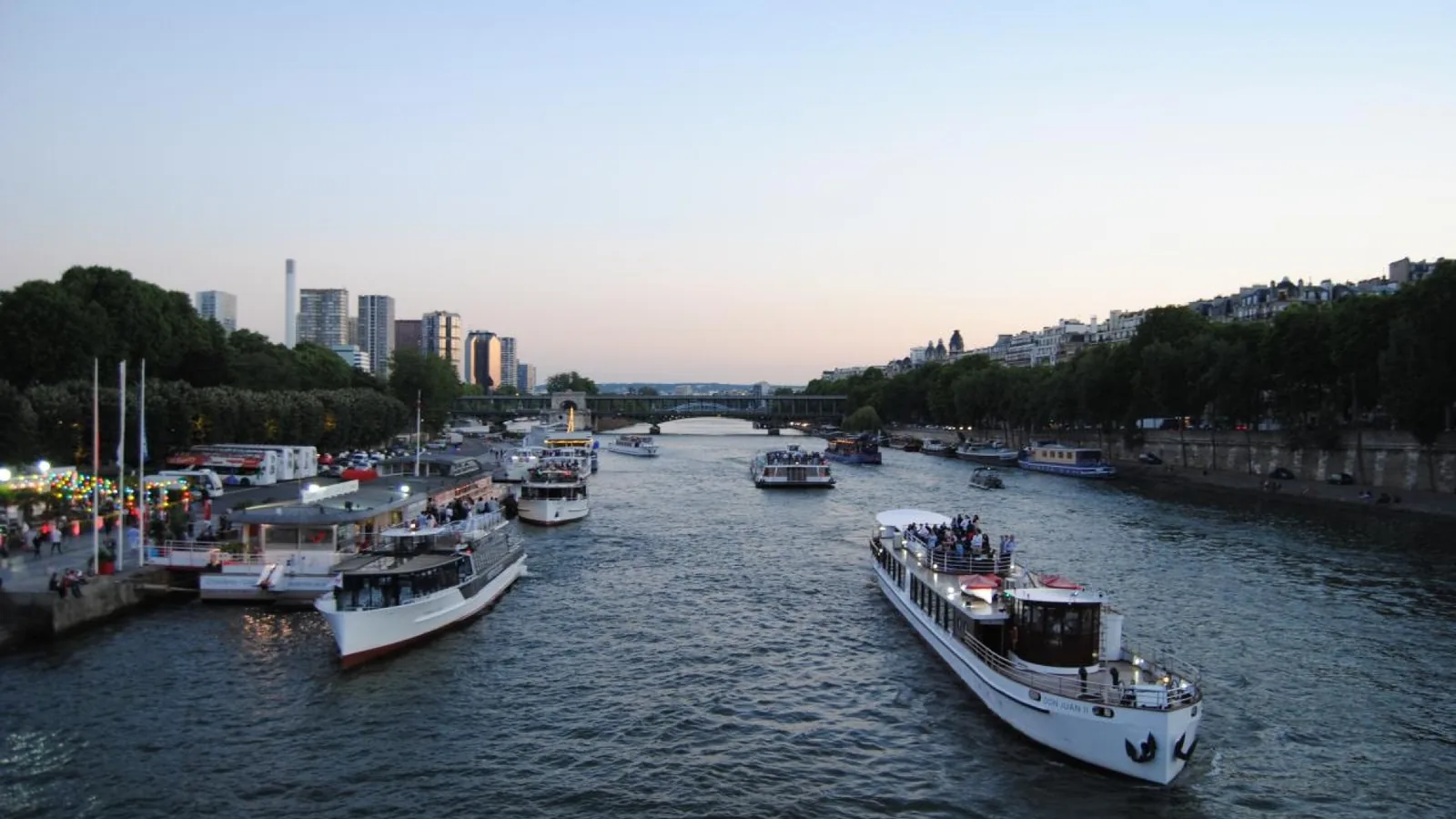 Seine River cruise boats in Paris around sunset