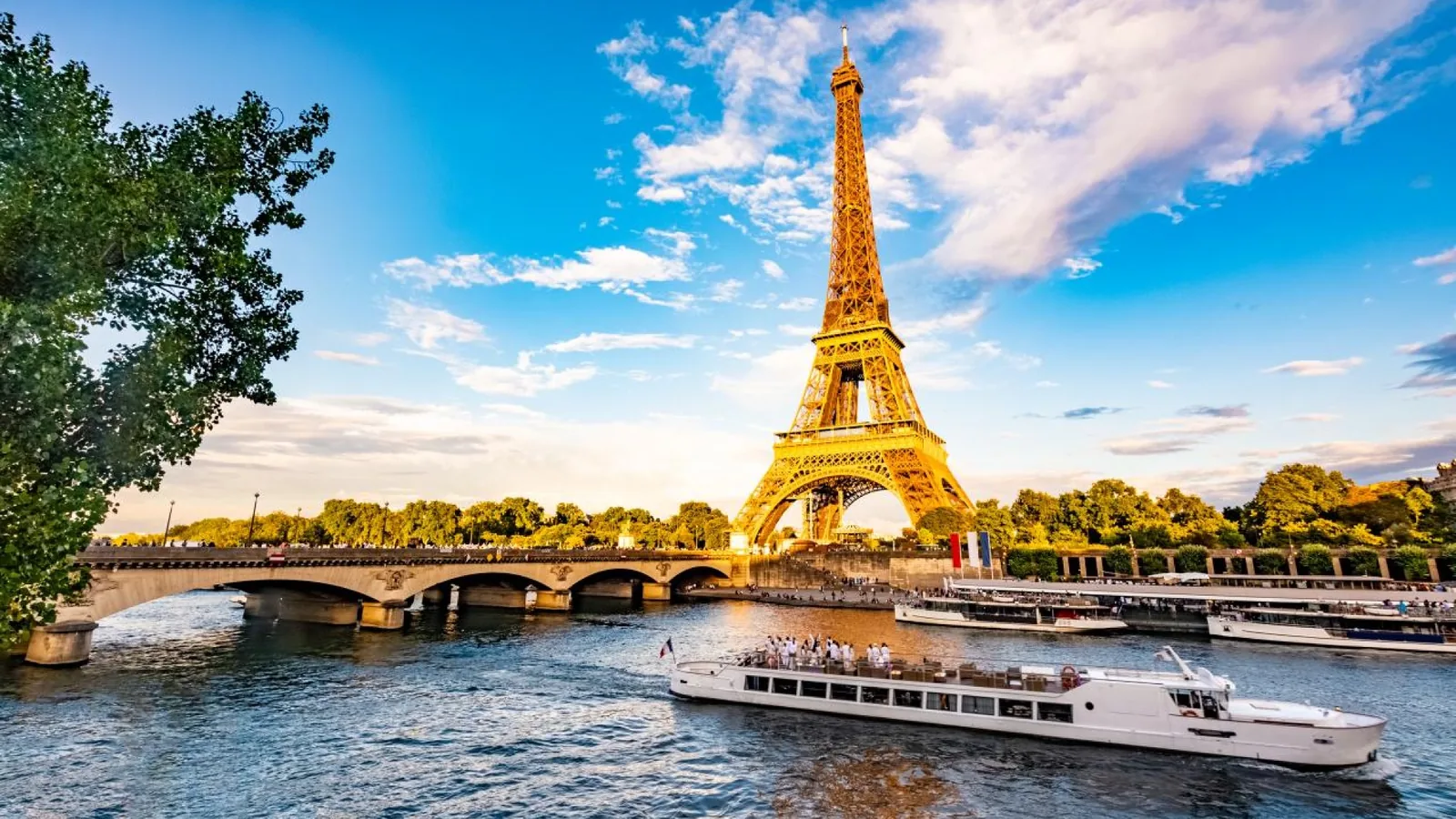 Sightseeing boat passing the Eiffel Tower in Paris