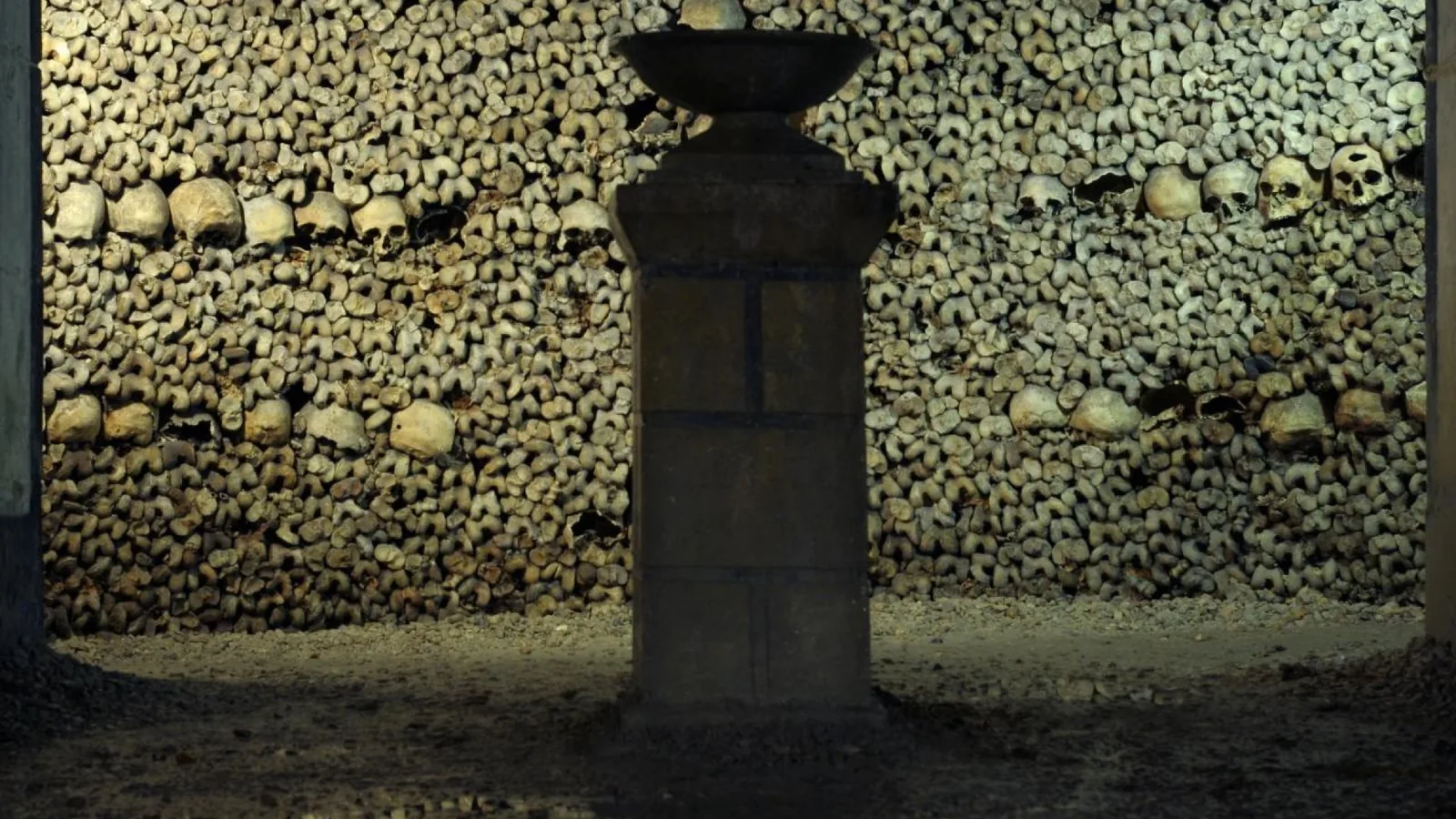 Bone and skull walls inside the Paris Catacombs underground ossuary