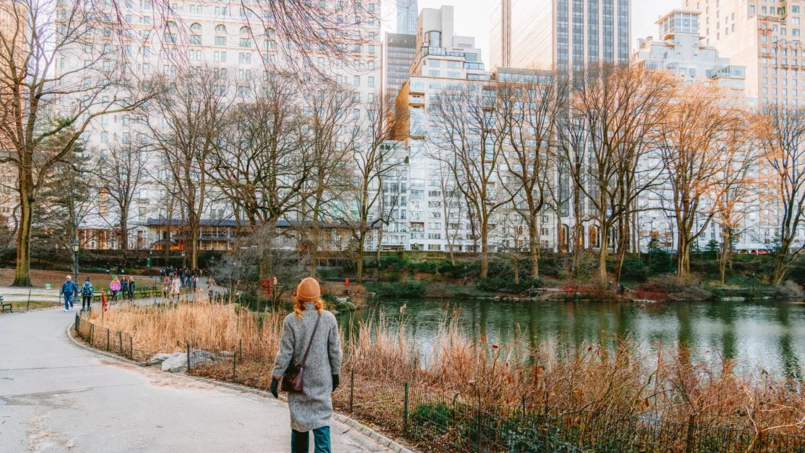 A visitor walking beside a pond in Central Park during a Thanksgiving visit to New York