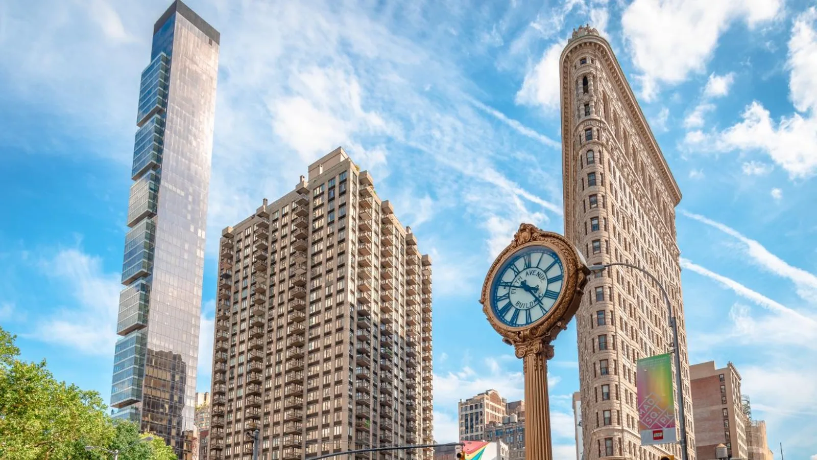 Flatiron Building and an ornate street clock beside Madison Square Park in Manhattan