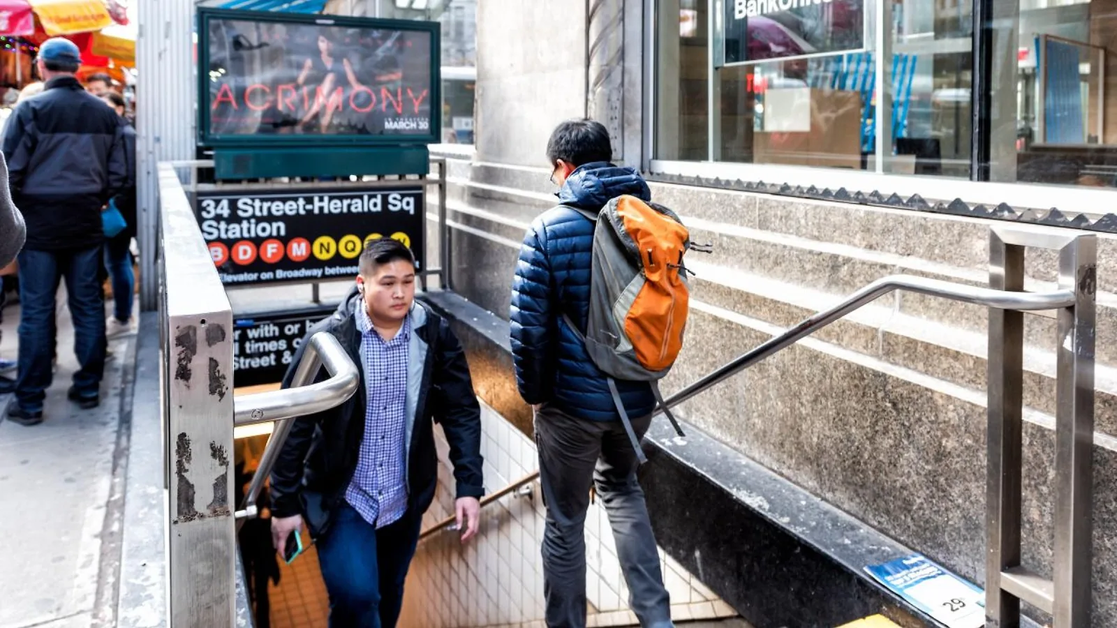 Pedestrians using the 34 St–Herald Sq subway entrance in Midtown Manhattan