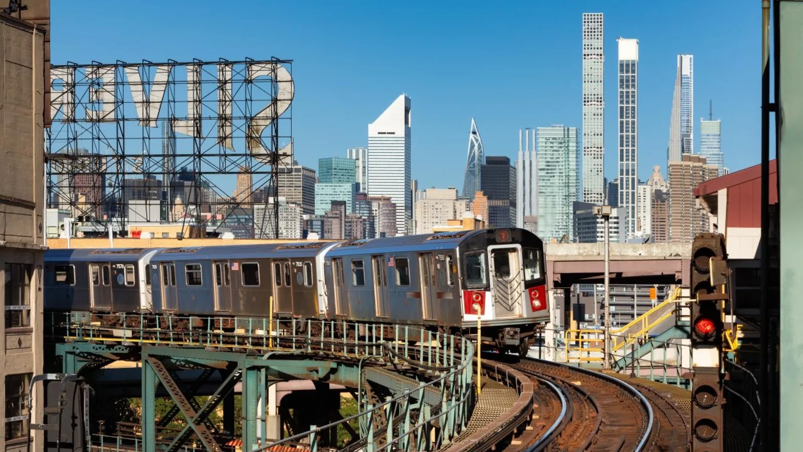 Subway train on elevated tracks at Queensboro Plaza in Long Island City, a base for a stay in NYC