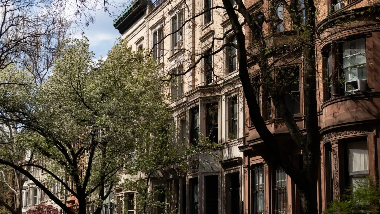Brownstone homes and trees on the Upper West Side, a residential area to stay in NYC with kids